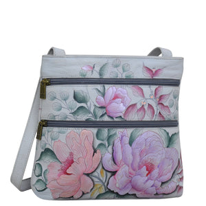 Anuschka style 447, handpainted Medium Crossbody With Double Zip Pockets. Bel Fiori Painted in Grey Color. Featuring three multipurpose pockets and key holder and rear optical case with hook and loop fastener.