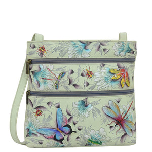 Anuschka style 447, handpainted Medium Crossbody With Double Zip Pockets. Wondrous Wings Painted in Green/Mint Color. Featuring three multipurpose pockets and key holder and rear optical case with hook and loop fastener.