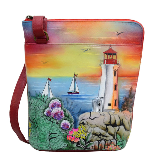Anuschka style 493, handpainted Organizer Crossbody With Extended Side Zipper. Guiding Light Painted in Orange Color. Featuring inside zippered partition pocket, zippered back wall pocket Multi-purpose pocket, two penholders and pullout credit card/ ID holder.