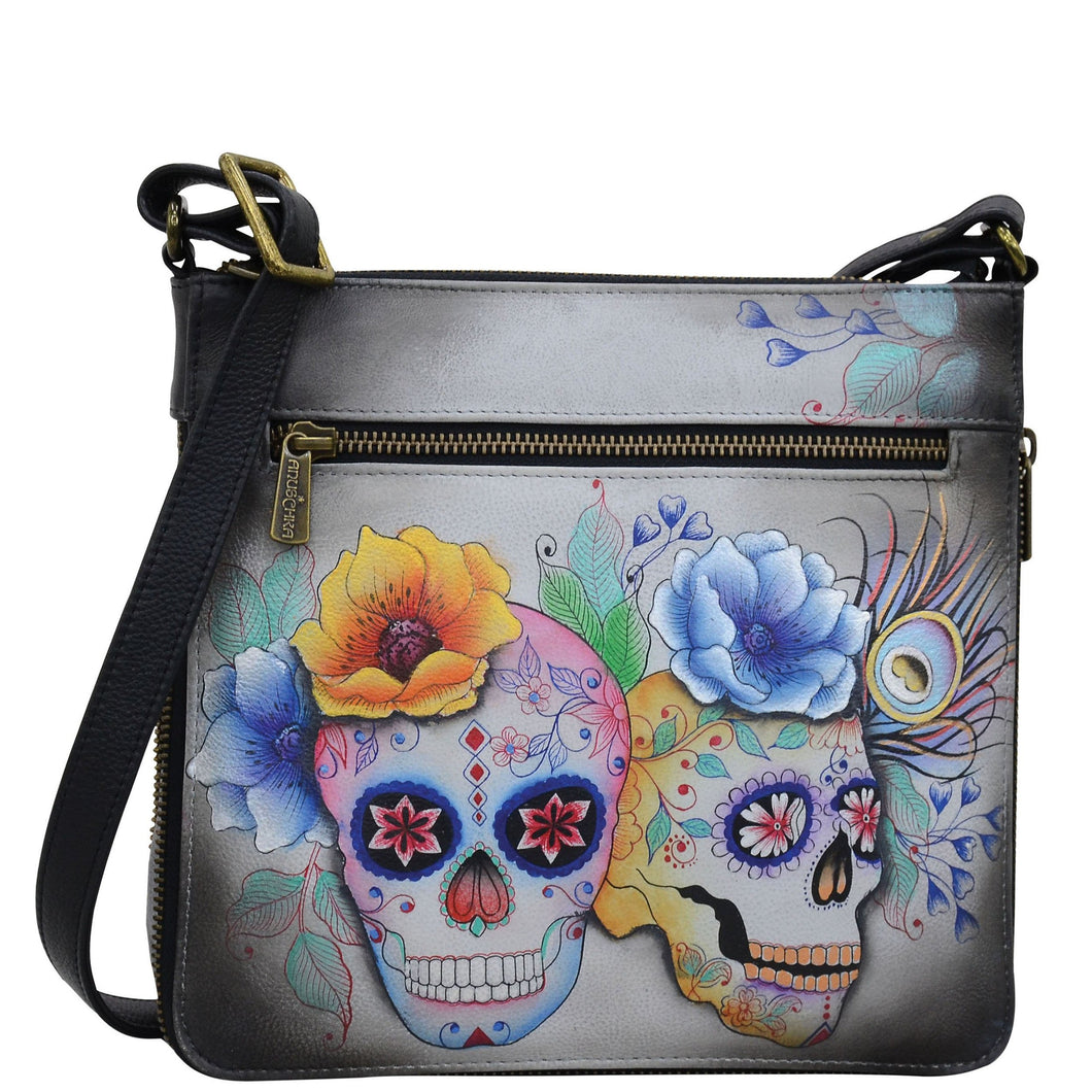 Anuschka style 550, handpainted Expandable Travel Crossbody. Calaveras de Azúcar Painted in Grey Color. Featuring inside one full length zippered wall pocket, one open wall pocket, two multipurpose pockets.