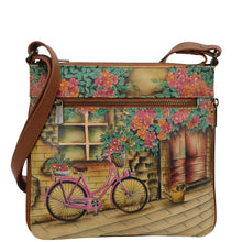 Load image into Gallery viewer, Anuschka style 550, handpainted Expandable Travel Crossbody. Vintage bycicle Painted in Tan Color. Featuring inside one full length zippered wall pocket, one open wall pocket, two multipurpose pockets.

