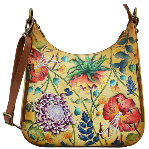 Anuschka style 662, handpainted Convertible Slim Hobo With Crossbody Strap. Caribbean Garden Painted in Tan Color. Featuring inside zippered wall pocket, one open wall pocket, two multipurpose pockets with gusset and rear full length zippered pocket, slip in cell pocket.