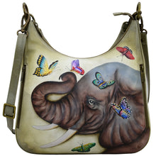 Load image into Gallery viewer, Anuschka style 662, handpainted Convertible Slim Hobo With Crossbody Strap. Gentle Giant Painted in Multi Color. Featuring inside zippered wall pocket, one open wall pocket, two multipurpose pockets with gusset and rear full length zippered pocket, slip in cell pocket.
