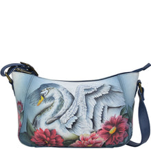 Load image into Gallery viewer, Anuschka style 670, handpainted Everyday Shoulder Hobo. Swan Song Painted in Multi Color. Featuring inside one zippered wall pocket, two multipurpose pockets, rear full length zippered pocket with adjustable shoulder strap.
