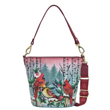 Load image into Gallery viewer, Anuschka style 699, Handpainted Tall Bucket Hobo. Snowy Cardinal painting in Multi color. Featuring Rear full length zip pocket, slip in cell pocket.
