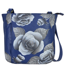Load image into Gallery viewer, Anna by Anuschka style 8341, handpainted Medium Crossbody. Romantic Rose Blue painting in Blue color. Featuring inside one zippered wall pocket, one open pocket, two multipurpose pockets, front zippered vertical pocket, rear full length zippered pocket and slip in cell pocket.
