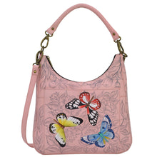 Load image into Gallery viewer, Anna by Anuschka style 8467, handpainted Large Classic Hobo. Butterfly Garden painted in Pink/Peach color. Featuring inside zippered wall pocket, open wall pockets, two multipurpose open gusseted pockets and front full length pocket with magnetic closure.
